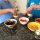 Kids have fun making their own mini trifle desserts.