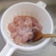 Velveted chicken is drained