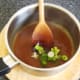 Spring onions are stirred in to chow mein sauce