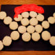 Use white, red, and black icing to decorate cupcakes.