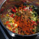 Adding the spices to the fish soup ingredients.