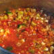 After the tomato puree has been added to the soup.