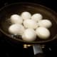 Step 1: Cover eggs with water in pan. Put on stove. Heat to boiling. Boil 12 minutes. Take off the stove and pour off the hot water. Put eggs in ice water (which helps the shell to separate from the egg and makes peeling easier).