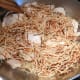 Add the browned fideo (vermicelli) over the cooked chicken.