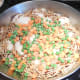 Add one cup of frozen peas and carrots (or vegetable of your choice) over the fideo and chicken. Spread evenly.