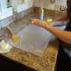 Rub the butter in so your hands are covered that way the treats won't stick to you.
