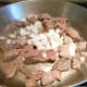 Add 1 cup of chopped onion to the browned stew meat.