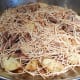 Add browned fideo (vermicelli) over the browned stew meat, onions, and potatoes.