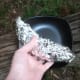 Wrap the banana in foil and put it into the fire.