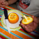 Cut off the top of the orange.