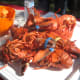 The lobsters will be a bright red color when they are fully cooked.