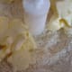 Adding the butter to the flour mixture.