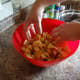 Pour the seasoned butter over the croutons and mix it so that all the bread pieces are coated.