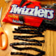 Cut 2 pieces of black licorice to create the spider legs.
