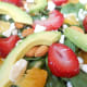 A delicious and tempting close-up of a very healthy spinach and avocado salad.