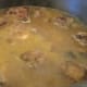 After browning, oxtails are covered with hot water and simmered for several hours.