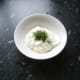 Chopped dill is stirred through soured cream