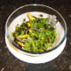 Salad is tossed with salt and pepper