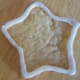 Create a border of thicker icing around the edge of the cookie