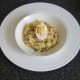 Deviled duck egg is laid on spiced rice