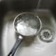Duck egg is placed under running cold water