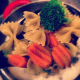 Tossing the pasta mixture with the margarine and cheeses.