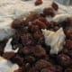 Add the rum-soaked sultanas to the cake batter.