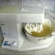 Mixing the gelatin mixture with the cream cheese. Start with the mixer on slow so that the water isn't thrown out.