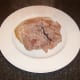 Cooked ham is removed to a plate to cool