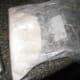 Pour flour into a bag or sack.
