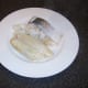 Poached fish is removed from milk