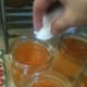 Use a damp towel or paper towel to wipe the rim of each jar. Make sure the rims are clear and clean or the jars may not seal correctly.