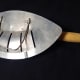This photo shows the attachment that hooks over the side of a pan.