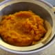 Drain the excess moisture from the puree by placing a sieve over a bowl.