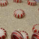 Put peppermints in a circle around the cake and one in the middle. Sprinkle on white decorating sugar for extra shine.