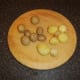 Cooked and cooled baby potatoes are peeled for roasting