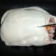 Duck skin is pierced all over with a sharp skewer