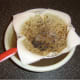 Duck stock is passed through a paper lined sieve to remove smallest impurities and fat
