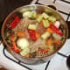 Water is added to the duck remains and vegetables to ensure everything is fully covered