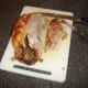 First breast fillet is sliced from the roast duck
