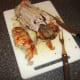 Second breast fillet is sliced from roast duck
