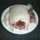 Giblets are removed from duck cavity and excess skin and fat is cut away