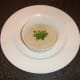 Cream of chestnut and roast duck soup ready for service