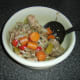 Solids are lifted out of the cooked and cooled stock with a large slotted spoon