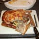 Removing the first leg from the roast duck