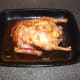 Roast duck is removed from oven