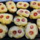 Mash the surplus potatoes, refill the skins, top with cheese and tomatoes.