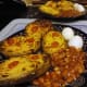 Stuffed potato Jackets with potato cheese and onion sauce served with hardboiled egg and baked beans