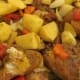 Seasoned, raw chicken leg pieces and potatoes are ready for browning.