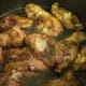 Browned chicken is placed in large pot or Dutch oven with 2 inches water.